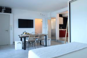 a bedroom with a table and chairs and a kitchen at Villa Kastro in Parikia