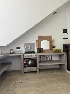a kitchen with a stove and a counter top at Far view villa in Galle