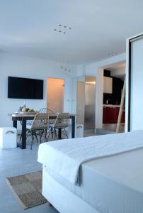 a bedroom with a bed and a table and chairs at Villa Kastro in Parikia