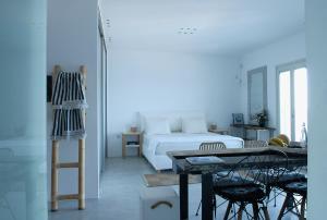 a bedroom with a bed and a table and chairs at Villa Kastro in Parikia