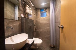 a bathroom with a sink and a toilet at Shyanu Lords Eco Inn Airoli-Near Mindspace in Navi Mumbai +45 photos