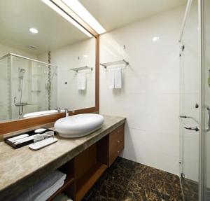 a bathroom with a white sink and a shower at Guanko Hotel in Chiayi City +16 photos