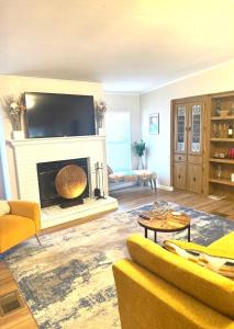 a living room with a fireplace with a flat screen tv at Flossies in Seabrook