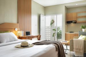 a bedroom with a bed with a hat on it at Deva Bali Apartement in Kerobokan