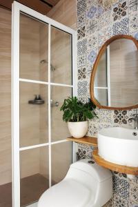 a bathroom with a shower and a toilet and a sink at Deva Bali Apartement in Kerobokan +16 photos
