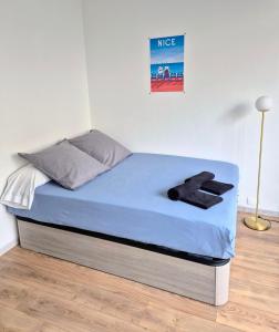 a bed in a room with a blue mattress at Royal Luxembourg Nice Prom' in Nice +6 photos