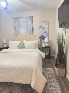 a bedroom with a large bed with a white bedspread at Flossies in Seabrook