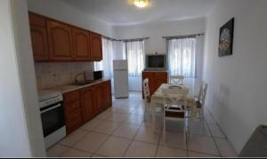 a kitchen with a table and a dining room at Aegina house1 in Egina