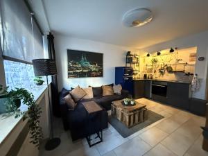 a living room with a couch and a table at Köln Apartment I in Cologne