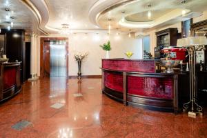 a lobby with a red counter in a building at Acapulco Hotel in Ploieşti