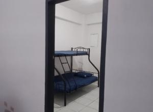 a mirror reflection of a room with a bunk bed at Condo Unit 5A in Batangas City in Batangas City