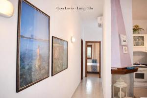 a hallway with two large pictures on the wall at Casa Lucia vicino al mare in Budoni +11 photos