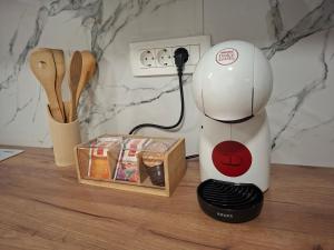 a white blender sitting on a counter next to a box at Studio apartman Aria in Đakovo