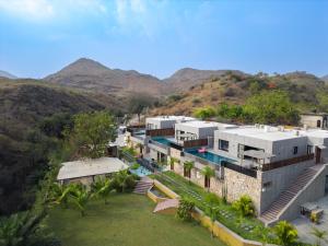 an aerial view of a building with a mountain at Kaizen Eirene Luxe Villas, Udaipur in Nāi