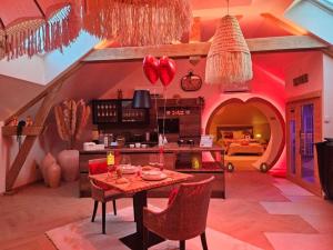 a living room with a table with chairs and a kitchen at Romantic Love - So Lovely in Bailleval