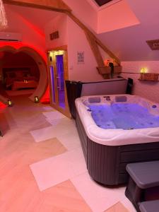 a large jacuzzi tub in the middle of a room at Romantic Love - So Lovely in Bailleval