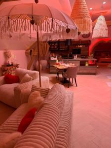 a living room with two couches and an umbrella at Romantic Love - So Lovely in Bailleval