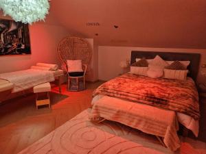 a bedroom with a bed and a table and a chair at Romantic Love - So Lovely in Bailleval