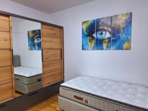 a bedroom with a bed and a large painting on the wall at Miris Mora in Rafailovici