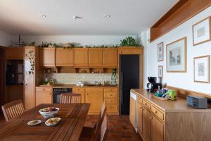 a kitchen with wooden cabinets and a wooden table in a room at Villa KATHERINA G in Schinias