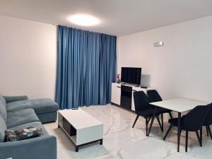a living room with a couch and a table at Miris Mora in Rafailovici