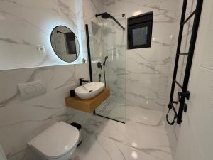 a bathroom with a toilet and a sink and a shower at Miris Mora in Rafailovici +39 photos