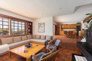 a living room with a couch and a table at Villa KATHERINA G in Schinias