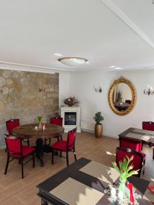 a living room with a table and chairs and a mirror at Villa Märchenland in Kurort Altenberg