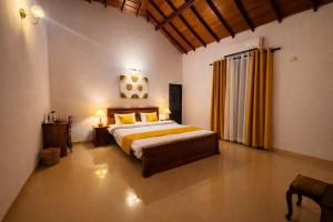a bedroom with a bed and two lamps in it at The Green Escape in Miriswatta