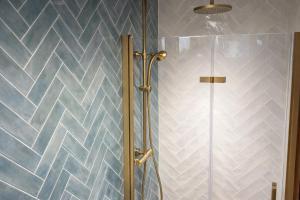 a bathroom with a shower with a glass door at El Refugio de Redo - balcón a los Picos de Europa in Camaleño +28 photos