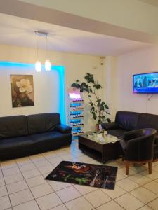 a living room with two couches and a coffee table at PENSIUNEA HORA in Braşov