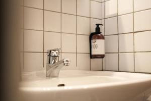 a soap bottle sitting on top of a bathroom sink at Hotel Fortini in Madonna di Campiglio +44 photos