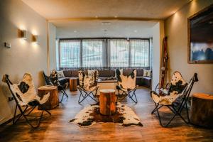 a living room filled with chairs and a couch at Hotel Fortini in Madonna di Campiglio