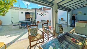 a patio with chairs and a table and a fireplace at La Vieja Parra in La Puerta de Segura