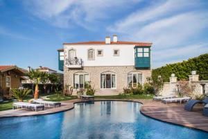 a house with a swimming pool in front of a house at Müptela Alaçatı in Çeşme