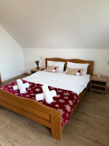 a bedroom with a large bed with towels on it at Complex Turistic Brândușa in Avrig