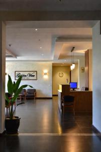 a lobby with a dining room and a living room at Golden view hotel Tanzania in Dar es Salaam