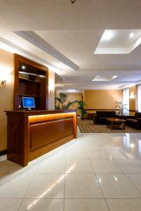 a lobby with a reception desk and a living room at Golden view hotel Tanzania in Dar es Salaam