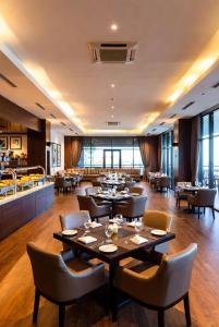 a dining room with tables and chairs and a restaurant at Golden view hotel Tanzania in Dar es Salaam