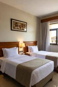 a hotel room with two beds and a window at Golden view hotel Tanzania in Dar es Salaam +72 photos