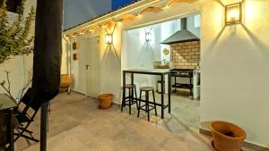 a kitchen with a counter and stools in a room at La Vieja Parra in La Puerta de Segura