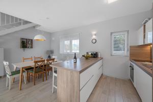 a kitchen with a table and a dining room at House Degenia in Lovinac
