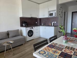 a kitchen and living room with a couch and a table at Sunny studio in Shartrez in Shkorpilovtsi