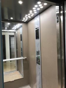 a row of elevators in a bathroom with mirrors at Sunny studio in Shartrez in Shkorpilovtsi