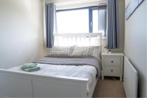 a small bedroom with a bed and a window at Moat View Donaghadee in Donaghadee