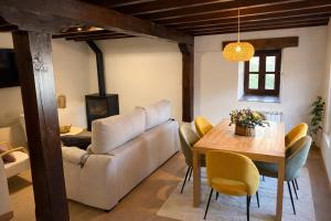 a living room with a table and a couch at El Refugio de Redo - balcón a los Picos de Europa in Camaleño