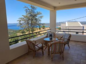a balcony with chairs and a table with a view at Big Terrace 180 view to sea in Akritokhórion