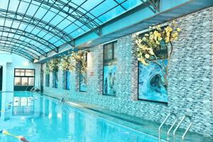 a swimming pool in a building with a glass ceiling at The Sun Backpacker Hostel in Ninh Binh