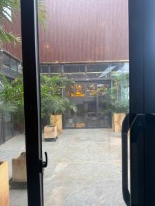 an open door to a courtyard with potted plants at The Sun Backpacker Hostel in Ninh Binh