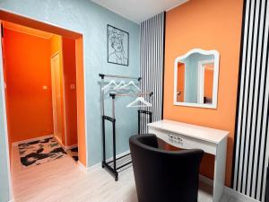 a bathroom with a vanity and a mirror and a chair at Velonia Guest House in Sozopol
